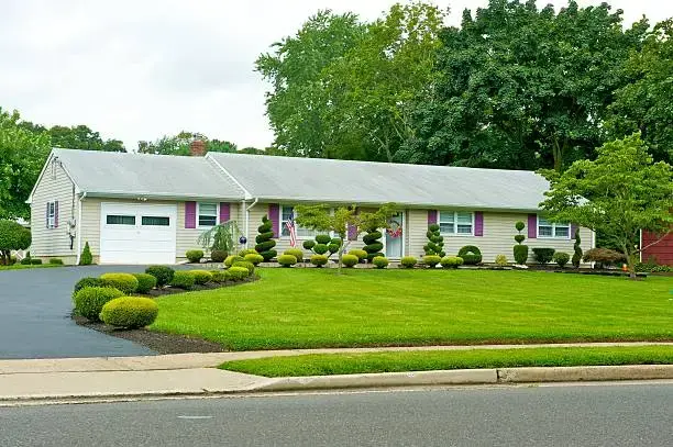 Single-story furnished rental house with landscaped front lawn, ideal for mid term rentals in New Jersey.