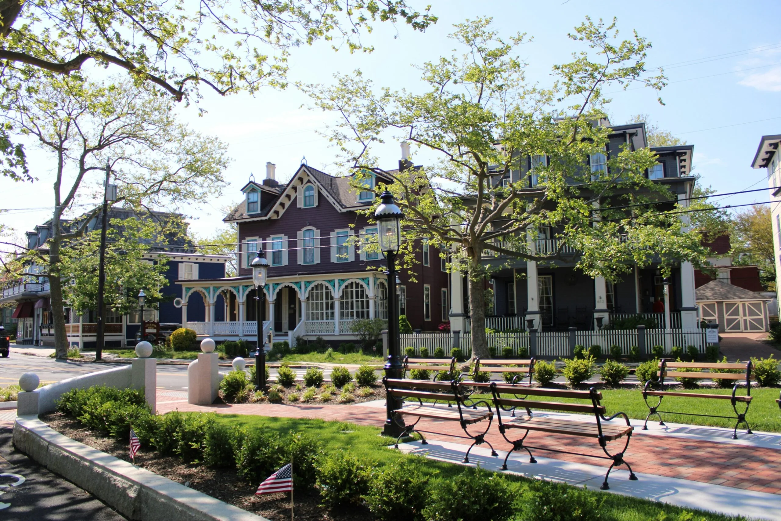 Historic homes and tree-lined neighborhood park with benches in a New Jersey residential community.